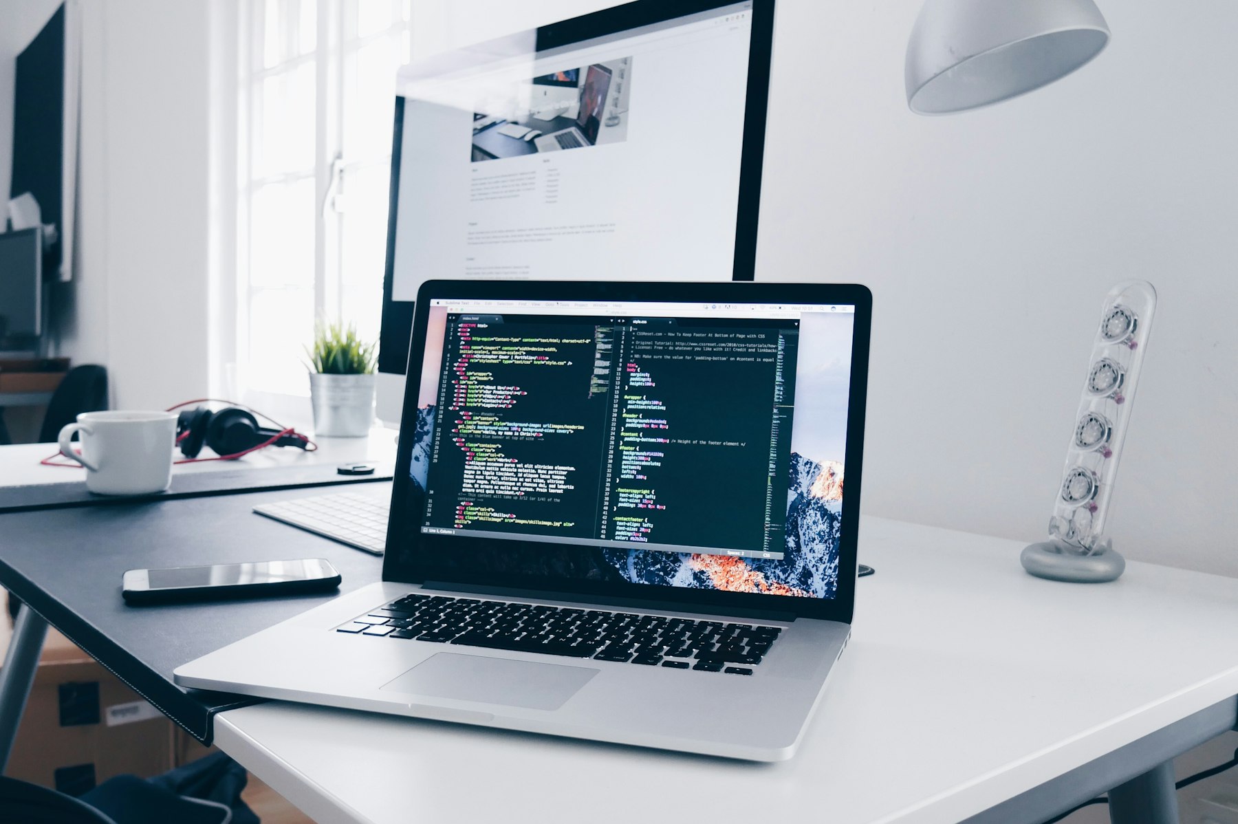 Laptop and monitor in a focused web-development workspace